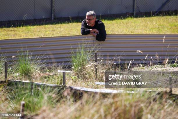 This picture taken on March 25, 2024 shows Professor Bernd Gruber from the University of Canberra checking on an enclosure housing grassland earless...