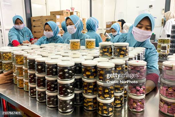 Employees are putting cookies into jars at the J&amp;C Cookies factory in Bandung, Indonesia, on March 27, 2024. The cookie manufacturer, J&amp;C...