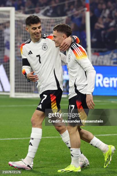 Florian Wirtz celebrates with Kai Havertz of Germany after scoring his team's first goal during the international friendly match between France and...