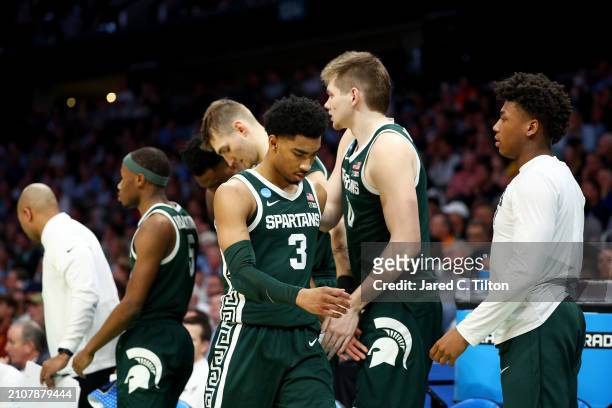 Jaden Akins of the Michigan State Spartans looks down while walking to the bench during the second half against the North Carolina Tar Heels in the...