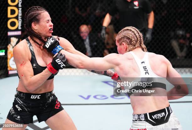 Daria Zhelezniakova of Russia punches Montserrat Rendon of Mexico in a bantamweight fight during the UFC Fight Night event at UFC APEX on March 23,...