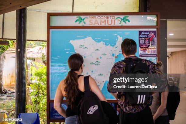 Sam, THAILAND Tourists look at a map of Koh Samui on March 23, 2024 in Koh Samui, Thailand. Thailand's tourism sector is experiencing a notable...