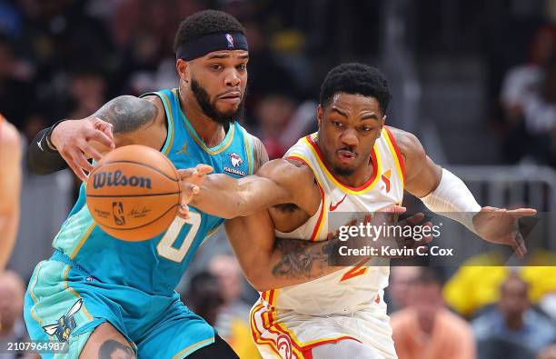 Trent Forrest of the Atlanta Hawks steals the ball from Miles Bridges of the Charlotte Hornets during the first quarter at State Farm Arena on March...