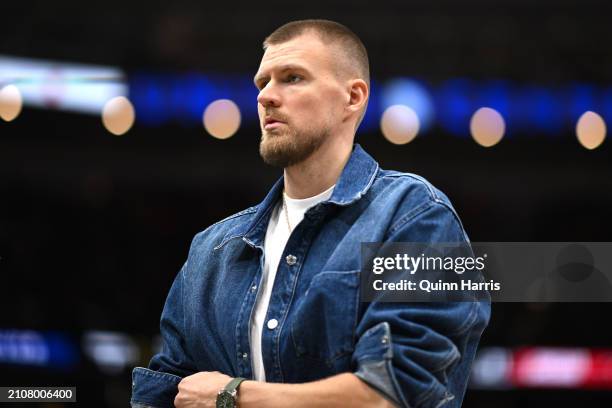 Kristaps Porzingis of the Boston Celtics looks on from the bench in the first half against the Chicago Bulls at the United Center on March 23, 2024...
