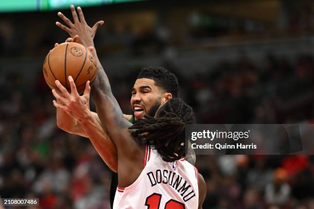 Jayson Tatum of the Boston Celtics is fouled in the first half against Ayo Dosunmu of the Chicago Bulls at the United Center on March 23, 2024 in...