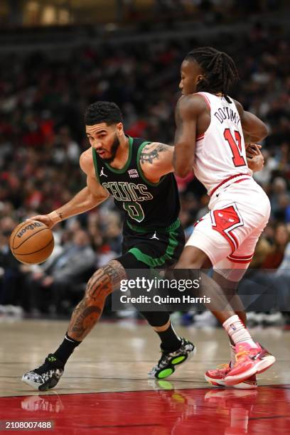 Jayson Tatum of the Boston Celtics drives with the basketball in the first half against Ayo Dosunmu of the Chicago Bulls at the United Center on...