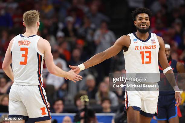 Quincy Guerrier of the Illinois Fighting Illini celebrates with Marcus Domask during the first half against the Duquesne Dukes in the second round of...