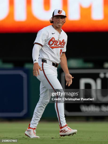 Jackson Holliday of the Baltimore Orioles stretches prior to a spring training game against the Atlanta Braves at Ed Smith Stadium on March 13, 2024...