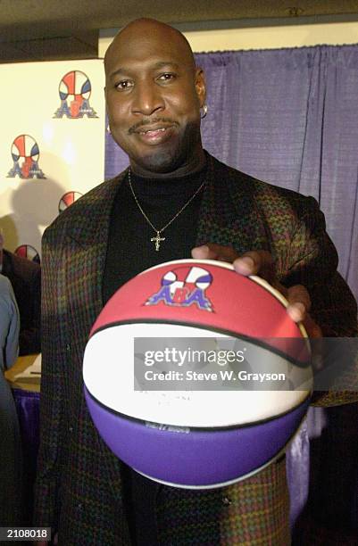 Former NBA/ABA player Daryl Dawkins palms a basketball at a press conference announcing the ABA 2000 basketball league at the Great Western Fourm,...