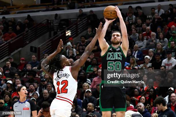 Svi Mykhailiuk of the Boston Celtics shoots in the first half against Ayo Dosunmu of the Chicago Bulls at the United Center on March 23, 2024 in...