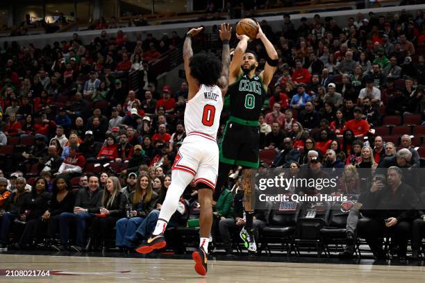 Jayson Tatum of the Boston Celtics shoots in the first half against Coby White of the Chicago Bulls at the United Center on March 23, 2024 in...