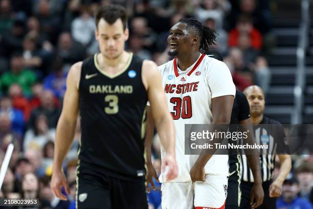 Burns Jr. #30 of the North Carolina State Wolfpack reacts as Jack Gohlke of the Oakland Golden Grizzlies looks on during overtime of a game in the...