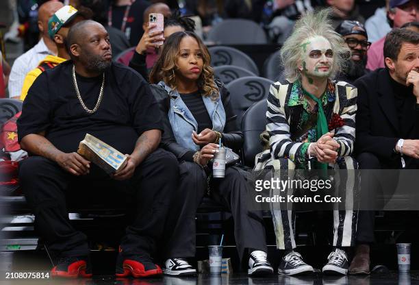 Killer Mike and Beetlejuice look during the third quarter of the game between the Atlanta Hawks and the Charlotte Hornets at State Farm Arena on...