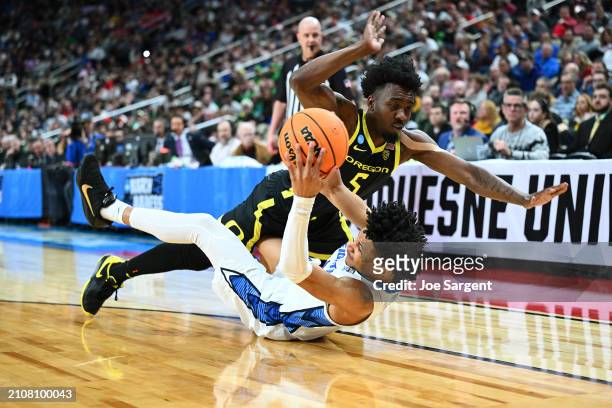 Jermaine Couisnard of the Oregon Ducks collides with Trey Alexander of the Creighton Bluejays during the first half of a game in the second round of...