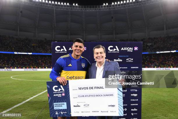 Marcos Rojo of Boca Juniors and Governor of Santiago del Estero Gerardo Zamora pose for a photo with the winner's check after a round of 64 match as...