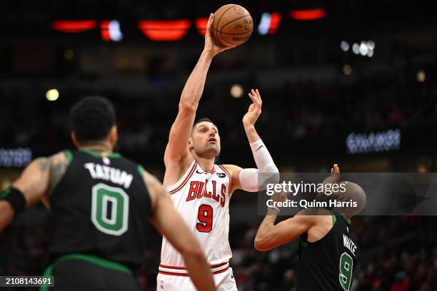 Nikola Vucevic of the Chicago Bulls shoots in the second half against Derrick White of the Boston Celtics at the United Center on March 23, 2024 in...