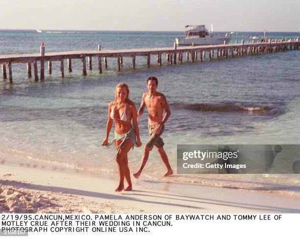 Canadian born actor Pamela Anderson and Greek born musicican Tommy Lee on the beach following their wedding, Cancun, Mexico, February 1995.