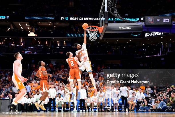 Jonas Aidoo of the Tennessee Volunteers drives to the basket against Chendall Weaver of the Texas Longhorns during the second round of the NCAA Men's...