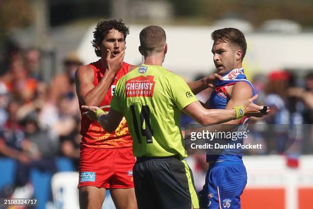 Rhylee West of the Bulldogs and Wil Powell of the Suns wrestle during the round two AFL match between Western Bulldogs and Gold Coast Suns at Mars...