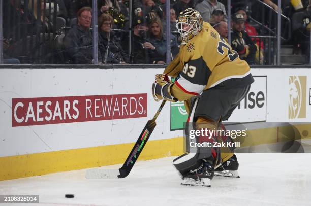 Adin Hill of the Vegas Golden Knights plays the puck during the third period against the Columbus Blue Jackets at T-Mobile Arena on March 23, 2024 in...