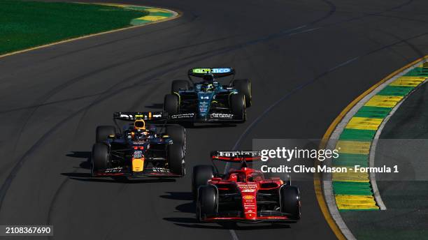 Charles Leclerc of Monaco driving the Ferrari SF-24 leads Sergio Perez of Mexico driving the Oracle Red Bull Racing RB20 and Fernando Alonso of Spain...