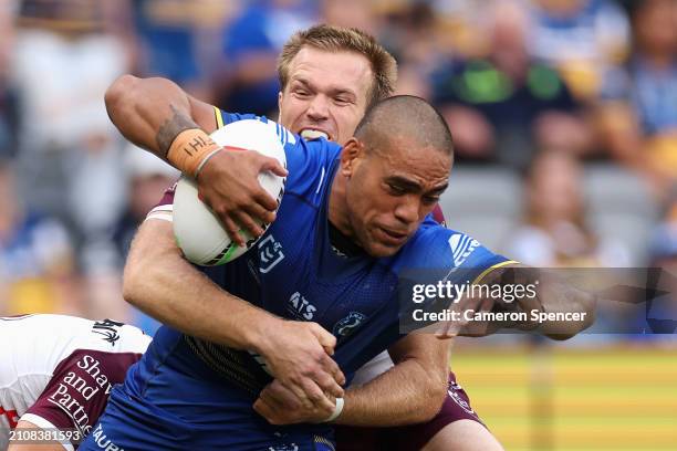 Joe Ofahengaue of the Eels is tackled during the round three NRL match between Parramatta Eels and Manly Sea Eagles at CommBank Stadium, on March 24...