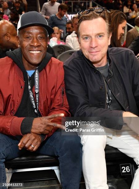 Don Cheadle and Ewan McGregor attend the game between the Atlanta Hawks and the Charlotte Hornets at State Farm Arena on March 23, 2024 in Atlanta,...