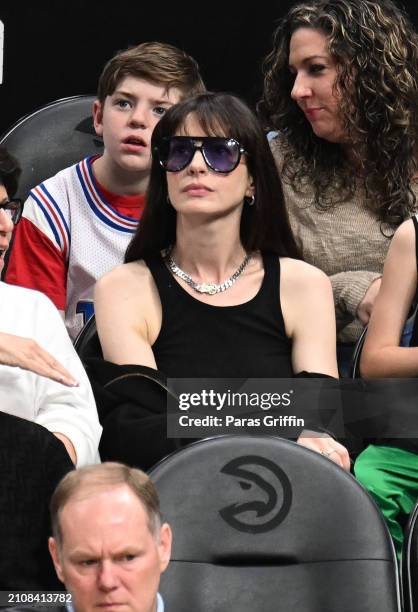 Actress Anne Hathaway attends the game between the Atlanta Hawks and the Charlotte Hornets at State Farm Arena on March 23, 2024 in Atlanta, Georgia....