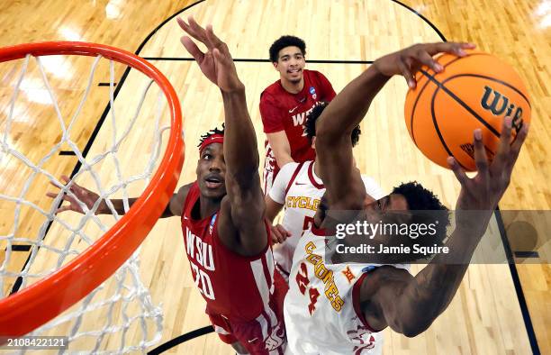 Hason Ward of the Iowa State Cyclones drives to the basket as Rueben Chinyelu of the Washington State Cougars defends during the second round game of...