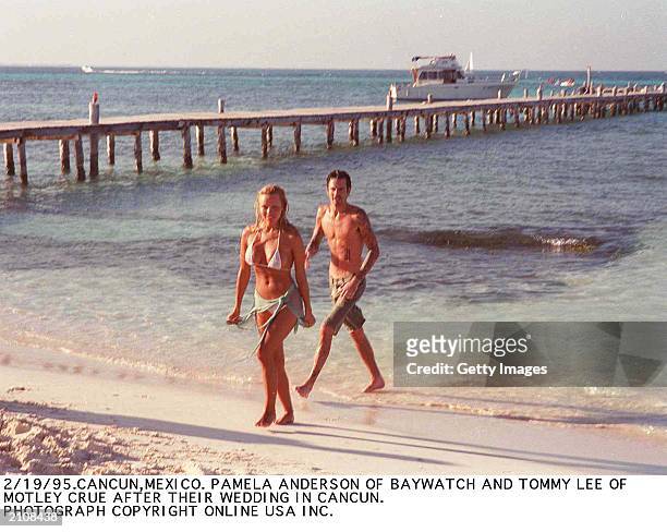 Canadian born actor Pamela Anderson and Greek born musicican Tommy Lee on the beach following their wedding, Cancun, Mexico, February 1995.