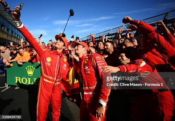 Race winner Carlos Sainz of Spain and Ferrari and Second placed Charles Leclerc of Monaco and Ferrari celebrate with their team in parc ferme during...