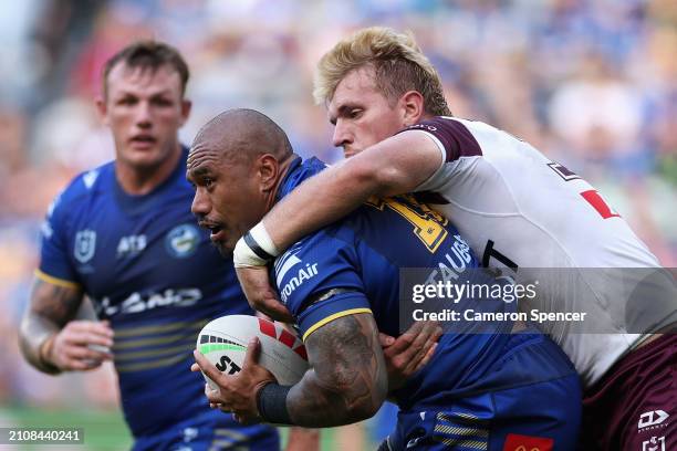Junior Paulo of the Eels is tackled during the round three NRL match between Parramatta Eels and Manly Sea Eagles at CommBank Stadium, on March 24 in...
