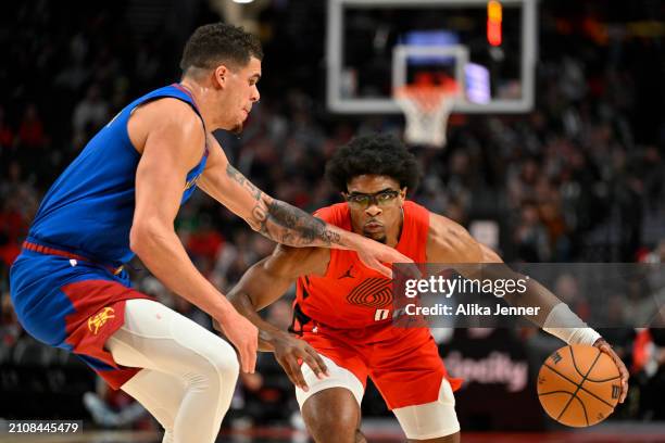 Scoot Henderson of the Portland Trail Blazers drives against Michael Porter Jr. #1 of the Denver Nuggets during the fourth quarter of the game at the...