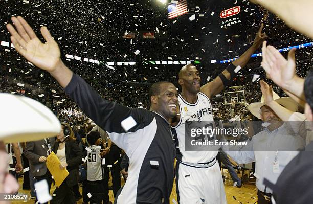 Malik Rose and Kevin Willis of the San Antonio Spurs celebrate defeating the New Jersey Nets in game six of the 2003 NBA Finals on June 15, 2003 at...