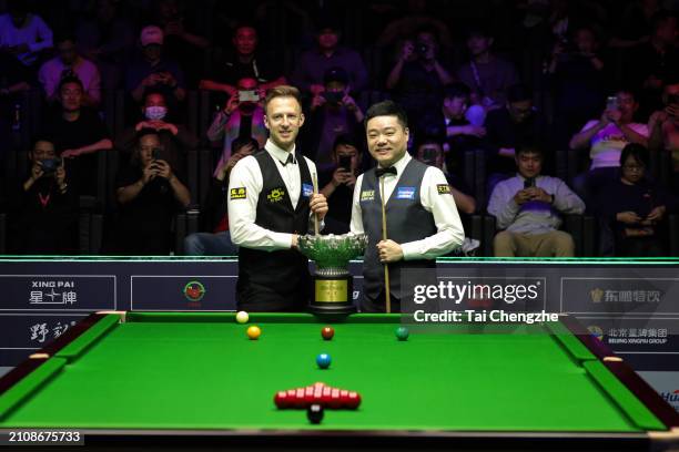 Judd Trump of England shakes hands with Ding Junhui of China on day seven of the 2024 Huading Nylon World Open at Yushan Sport Centre on March 24,...