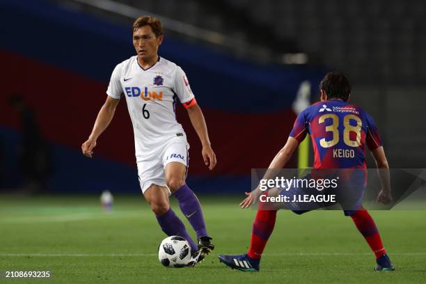 Toshihiro Aoyama of Sanfrecce Hiroshima controls the ball against Keigo Hgashi of FC Tokyo during the J.League J1 match between FC Tokyo and...