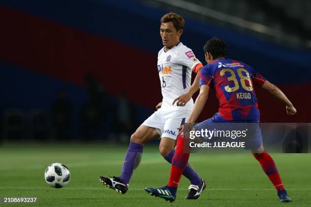 Toshihiro Aoyama of Sanfrecce Hiroshima controls the ball against Keigo Hgashi of FC Tokyo during the J.League J1 match between FC Tokyo and...