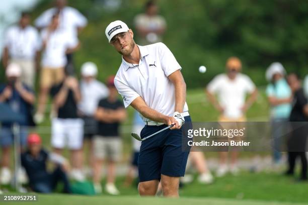 Jesper Svensson of Sweden pitches onto the green on hole 18 during Day Four of the Porsche Singapore Classic at Laguna National Golf Resort Club on...