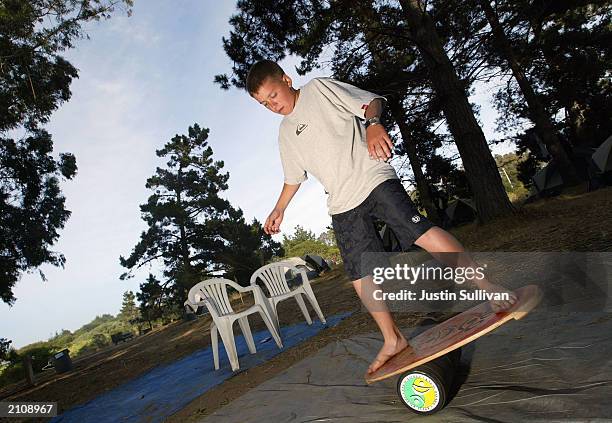 Thirteen-year-old Ben Mailkel practices his balance on an Indo Board at Club Ed International Surfing School June 23, 2003 in La Selva Beach,...