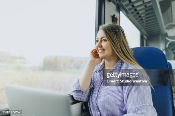 beautiful young woman using laptop while commuting by train - working on laptop in train top view imagens e fotografias de stock