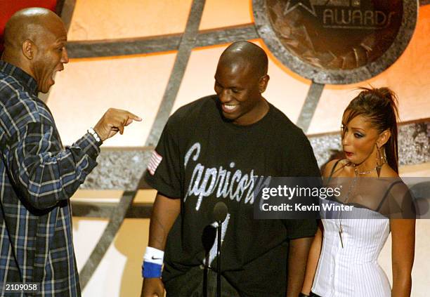 Actor Tom 'Tiny' Lister Jr. Speaks to singers Tyrese and Mya on stage as they present the award for "Best Actress" during the 3rd Annual BET Awards...