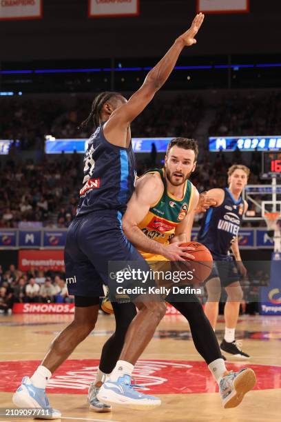 Sean Macdonald of the JackJumpers handles the ball against Ian Clark of United during game three of the NBL Championship Grand Final Series between...