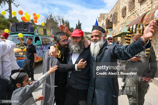 Jewish settlers wearing costumes celebrate Purim as Israeli security forces secure the celebrations on March 24, 2024 in Hebron, West Bank. This year...