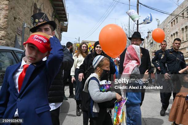 Jewish settlers wearing costumes celebrate Purim as Israeli security forces secure the celebrations on March 24, 2024 in Hebron, West Bank. This year...