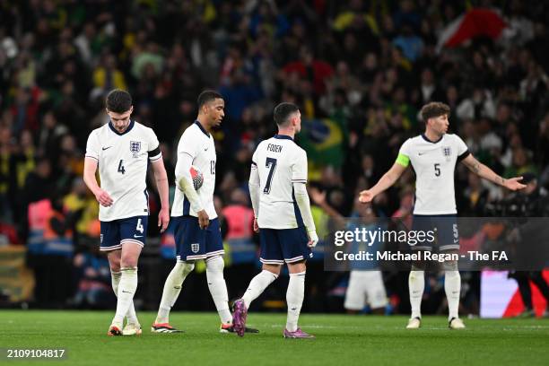 Declan Rice, Ezri Konza, Phil Foden and John Stones look dejected after the first Brazil goal during the international friendly match between England...