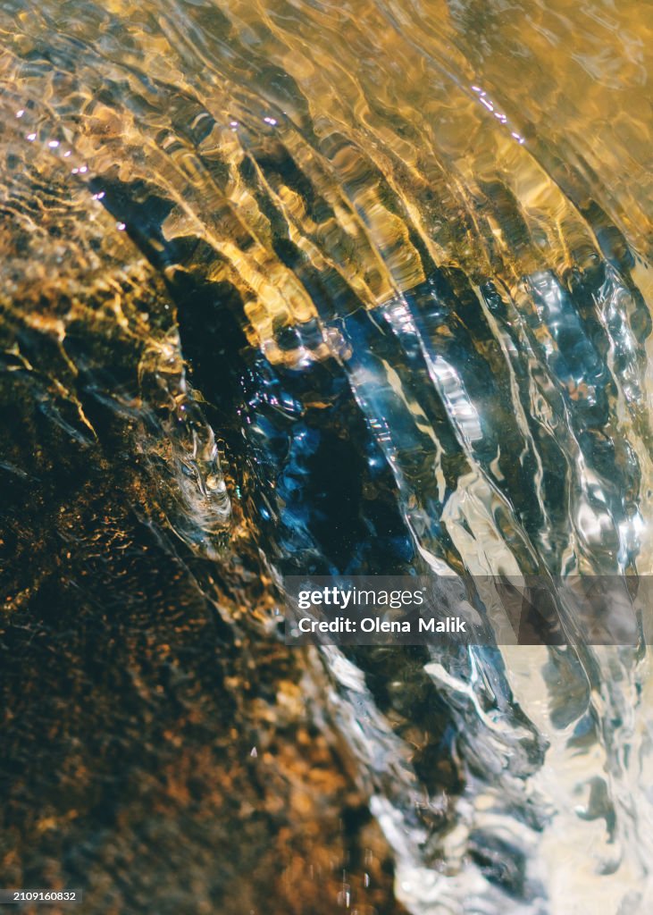 Close-up of a running water in a stream in the spring