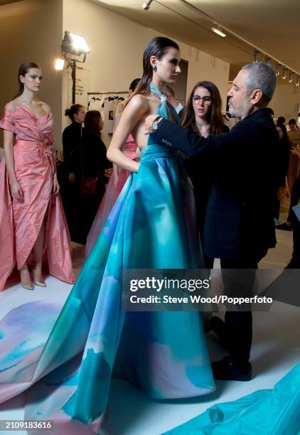 Designer Elie Saab with model Ivana Anic backstage backstage at his Couture show during Paris Fashion Week Spring/Summer 2019, she wears a full...