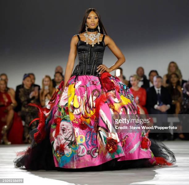 Naomi Campbell walks the runway at Fashion for Relief 2018 during the 71st annual Cannes Film Festival, she wears a Dolce and Gabbana gown comprising...