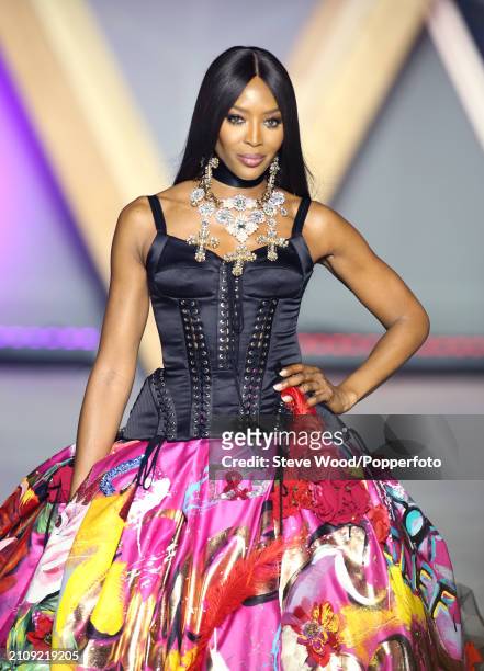 Naomi Campbell walks the runway at Fashion for Relief 2018 during the 71st annual Cannes Film Festival, she wears a Dolce and Gabbana gown comprising...