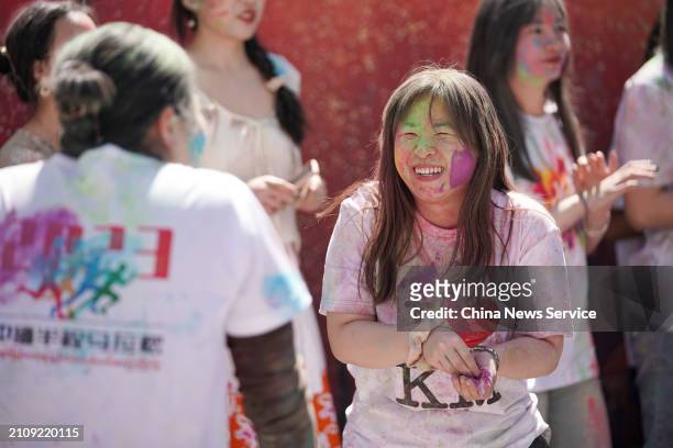 Local people celebrate the Indian festival Holi on March 24, 2024 in Kunming, Yunnan Province of China. Participants throw colored powder on each...